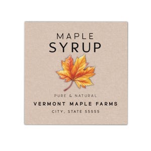May include: A square label with the words "MAPLE SYRUP" in black above a colorful maple leaf illustration. Below the leaf, the text reads "PURE & NATURAL" and "VERMONT MAPLE FARMS". The bottom of the label displays the city, state, and zip code.
