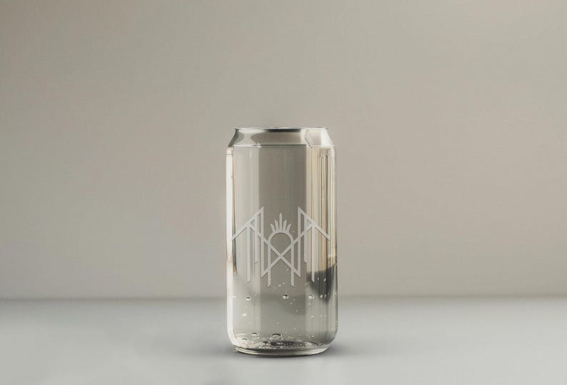 A clear glass can with water inside, featuring a logo or design on the side.