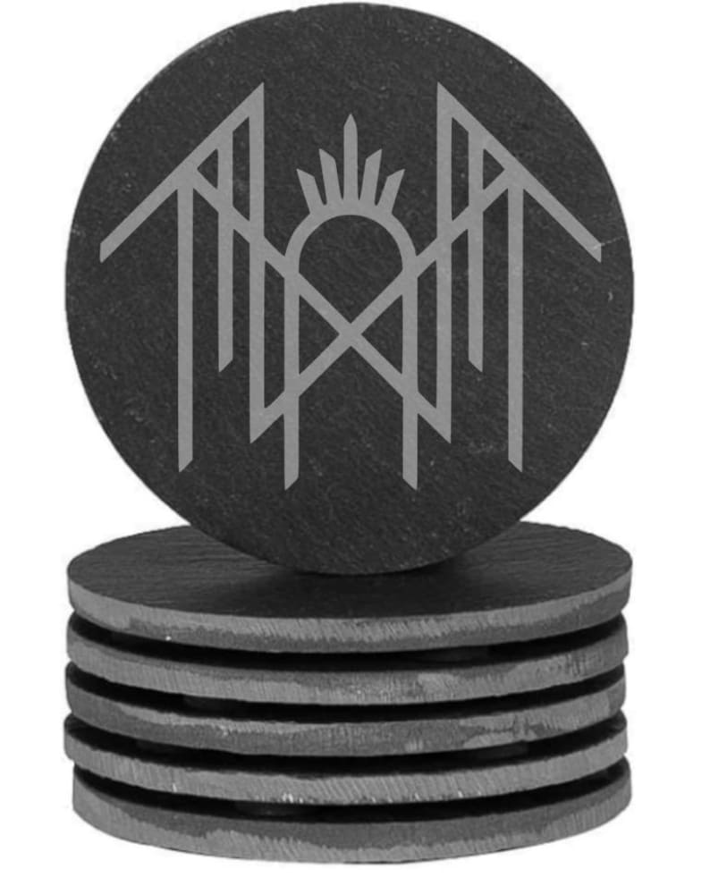 A stack of gray coasters with a circular design featuring a stylized bird or bird-like figure on top of it.