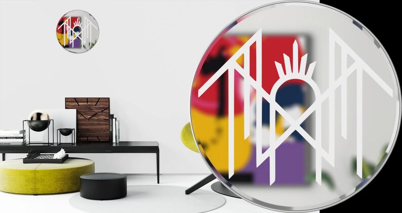 a modern and stylish living room with a large round mirror, a black coffee table, and various decorative items such as a clock, a vase, and a sculpture.