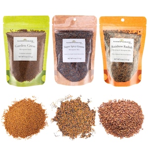May include: Three packets of microgreen seeds: Garden Cress, Super Spicy Greens, and Rainbow Radish. Each packet is labeled with the brand name and product details. Below the packets are three piles of seeds, each with a different color and texture.