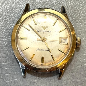 Vintage 70’s Wittnauer Automatic watch with Date window.10K Gold Filled Bezel Stainless Back.Winds Sets and keeps time.Spot on Dial 10 &2.