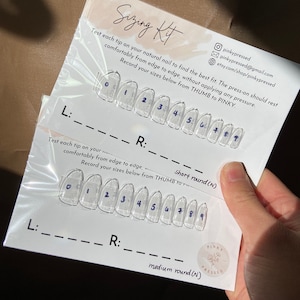 May include: A sizing kit for press-on nails. The kit includes ten clear plastic nail tips numbered 0-9. The kit also includes instructions for measuring your nail size. The instructions say to test each tip on your natural nail to find the best fit. The press-on should rest comfortably from edge to edge, without applying any pressure. Record your sizes below from thumb to pinky. The kit also includes a sticker that says "Pinky Pressed".