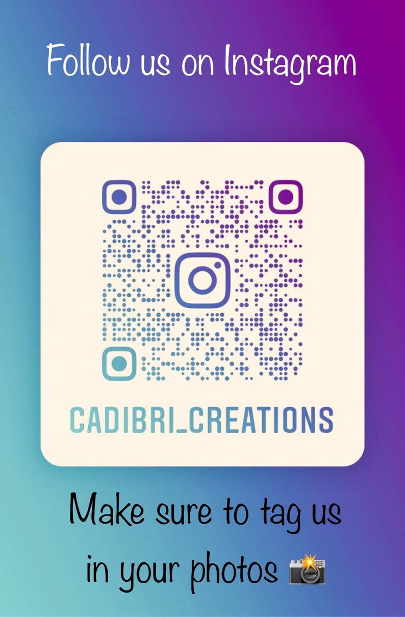 May include: A purple and blue gradient background with a white square in the center. The square contains a black and white Instagram QR code with a blue and white Instagram logo in the center. Below the QR code is the text "CADIBRI_CREATIONS". Below the square is the text "Make sure to tag us in your photos" with a camera emoji.