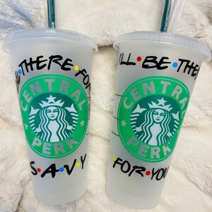 May include: Two clear plastic cups with black writing and a green Starbucks logo. The text on the cups reads "I'll be there for you" and "We were on a break".