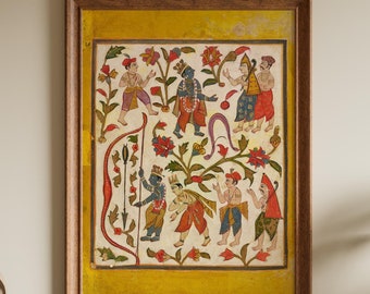 May include: A framed, colorful Indian artwork depicting figures in traditional attire amidst floral patterns. The artwork features a yellow border and a wooden frame, adding a touch of cultural elegance to the decor. The artwork is displayed on a wooden cabinet.