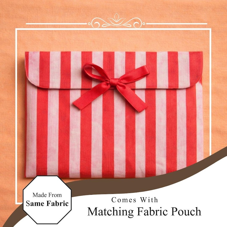 May include: A red and white striped fabric pouch with a matching red bow closure. The pouch is made from the same fabric and comes with a matching fabric pouch. The overall theme is gift packaging.