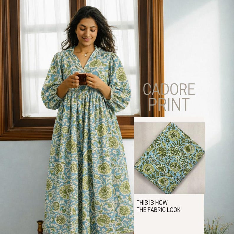 May include: A long-sleeved dress featuring a light blue and green floral pattern labeled Cadore Print. The dress has a V-neckline and a gathered waist. An inset shows a folded piece of the same floral fabric with the text This is how the fabric look.