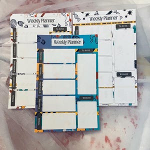 May include: Three weekly planner sheets with a crime scene theme. The sheets are white with black and yellow crime scene tape and have a blue and yellow pattern. The sheets have spaces for each day of the week and a to-do list section.