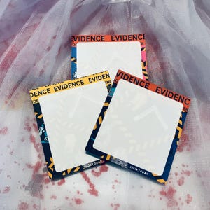 May include: Three blank white note cards with yellow and black caution tape borders. The tape reads "EVIDENCE" in red and black letters. The cards are on a white background with red splatter.