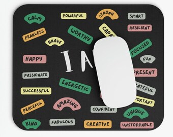 May include: Black mouse pad with the words "I am" in white surrounded by colorful words like "calm", "brave", "worthy", "energetic", "creative", "unique", and "unstoppable".