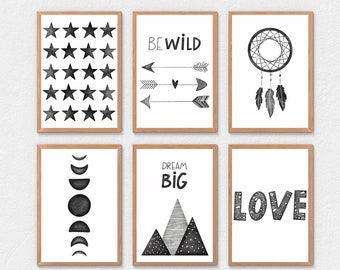 May include: Set of six black and white printable wall art prints with various designs, including stars, arrows, a dreamcatcher, a moon phases design, mountains, and the word "LOVE". The prints feature a minimalist style and include text such as "BE WILD" and "DREAM BIG".