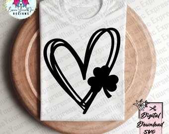 May include: A white t-shirt with a black outline of a heart with a shamrock inside. The design is perfect for St. Patrick's Day.