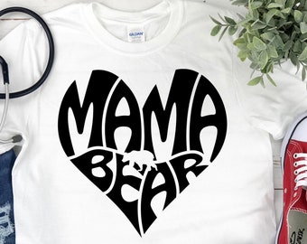 May include: White t-shirt with a black heart design that says "Mama Bear" with a small bear silhouette inside the heart.