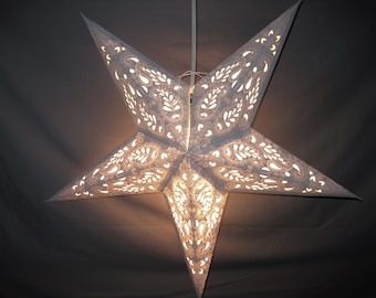 May include: A white paper star lantern with a delicate paisley pattern. The lantern is illuminated from within, casting a warm glow.