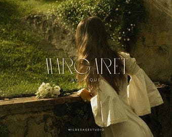 May include: A woman in a white dress with a flowing skirt stands in a garden setting. The text "MARGARET BOUTIQUE" is displayed in a minimalist font.