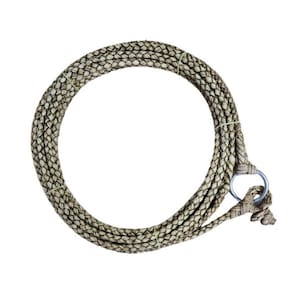 May include: A coiled, braided rope with a metal ring at one end. The rope is primarily beige with a subtle pattern of darker flecks. The rope is designed for equestrian use.