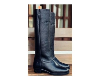 May include: A pair of black leather knee-high boots with a pointed toe and a low heel.