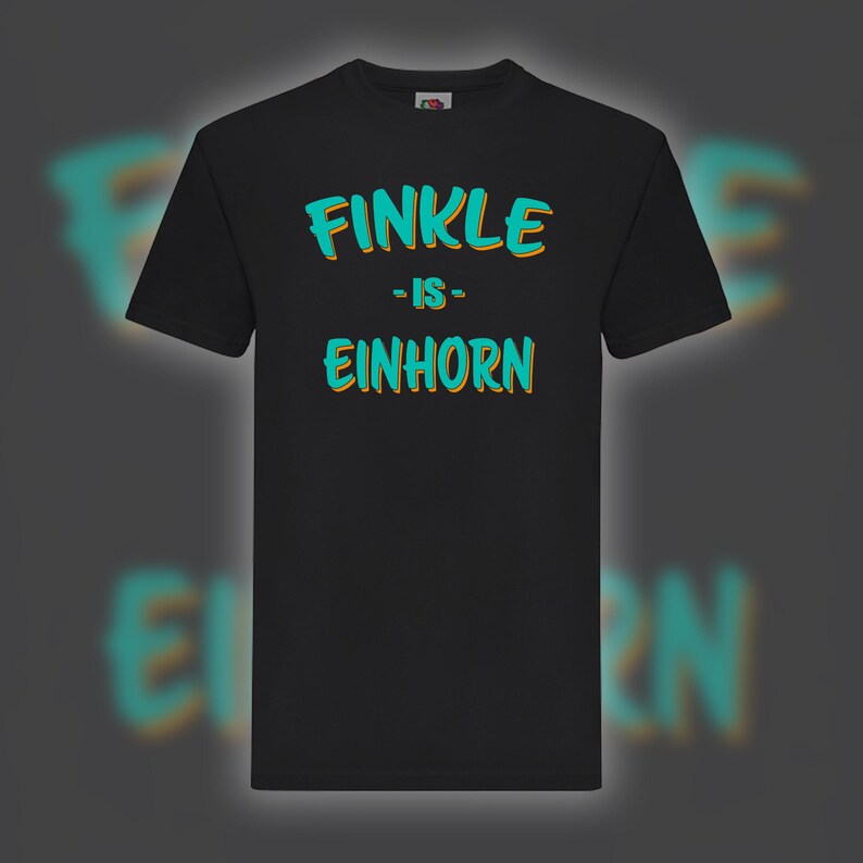 May include: Black t-shirt with the text "FINKLE - IS - EINHORN" in turquoise and orange lettering. The shirt is a classic crew neck style, suitable for casual wear. The design is centered on the front of the shirt.