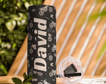 May include: A black stainless steel tumbler with a white design of motocross bikes and the name "David" printed on the side. The tumbler is sitting on a wooden table.
