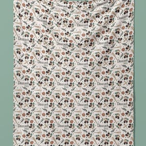May include: A white baby blanket with a repeating pattern of Mickey Mouse, baseball bats, baseballs, and the name "Dawson Paul".