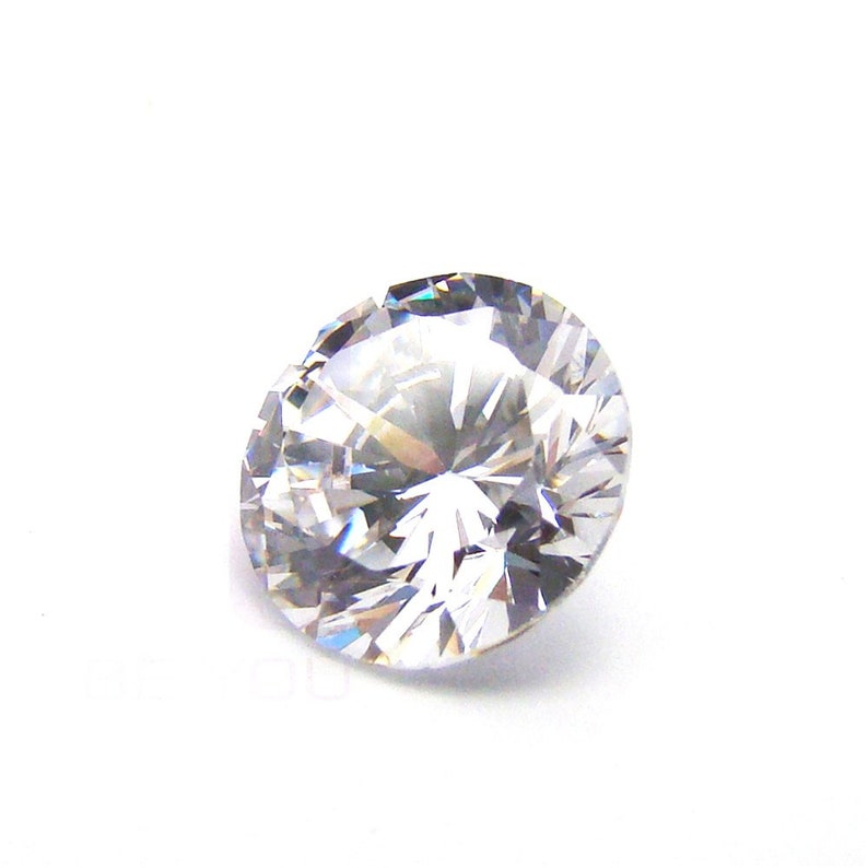 May include: A clear, round, faceted diamond gemstone.