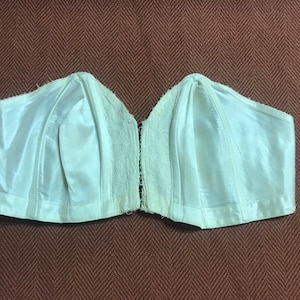 Elegant, vintage Strapless Bra with sweet eyelet connectors in front. 24 inches around without stretching the elastic.