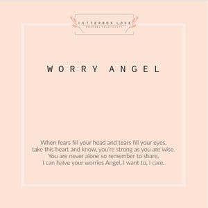 May include: A light peach-colored card with the words "WORRY ANGEL" in black. The card also includes the text "LETTERBOX LOVE POSTING POSITIVITY" and a poem about strength and sharing worries.