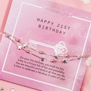 May include: A silver bracelet with star and bead accents is displayed on a pink card that reads "HAPPY 21ST BIRTHDAY." The card also includes the text "LETTERBOX LOVE" and a message about celebrating a 21st birthday.