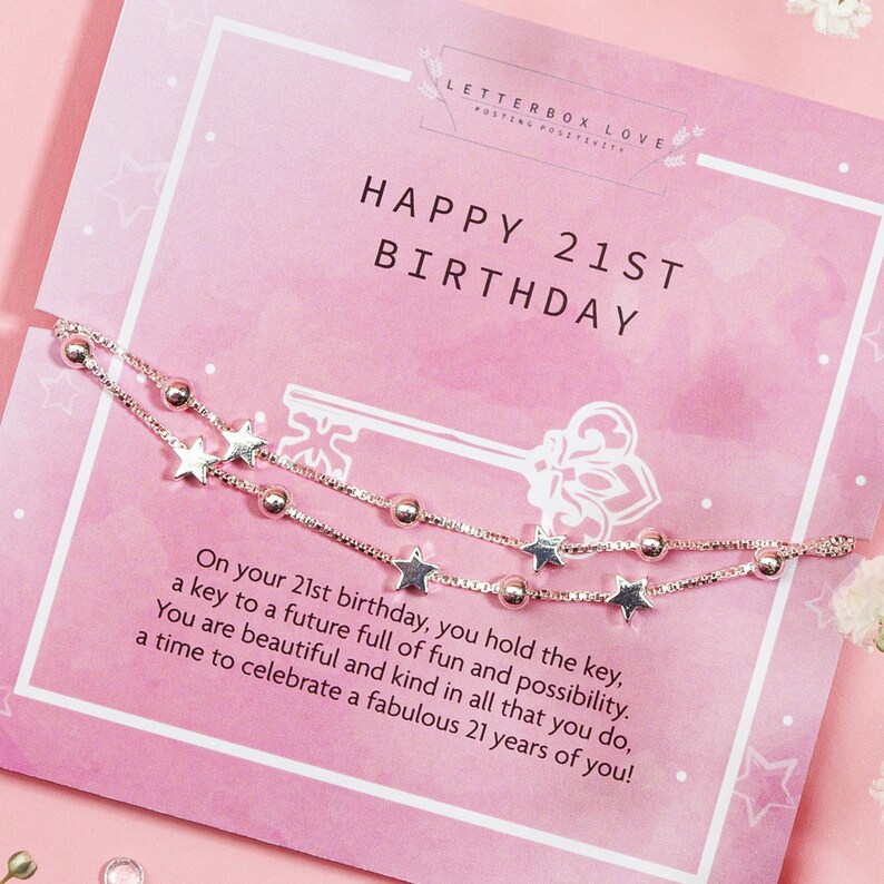 May include: A silver bracelet with star and bead accents is displayed on a pink card that reads "HAPPY 21ST BIRTHDAY." The card also includes the text "LETTERBOX LOVE" and a message about celebrating a 21st birthday.