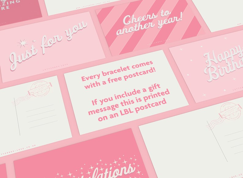 May include: A collection of pink and white postcards with various greetings. The cards feature phrases like "Just for you," "Cheers to another year," and "Happy Birthday." One card states, "Every bracelet comes with a free postcard!"