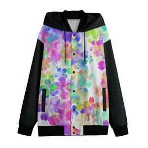 May include: A black and white hooded bomber jacket with a colorful floral print on the front. The jacket has a zipper closure and snap buttons.