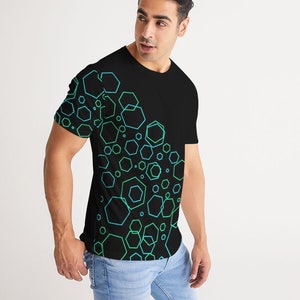 May include: A black t-shirt with a geometric pattern of green and blue hexagons on the right side of the shirt.