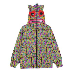 May include: A black zip-up hoodie with a colorful brick pattern and a monster face on the hood. The monster has red eyes, a pink mouth, and yellow teeth.