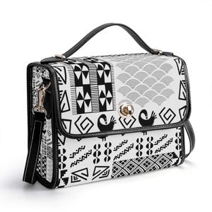 May include: A black and white patterned crossbody bag with a black leather strap and a gold clasp. The bag has a geometric design with a variety of shapes and patterns.