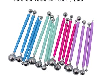 May include: Set of four stainless steel ball tools with handles in blue, green, pink, and purple. The tools are used for crafting and decorating.