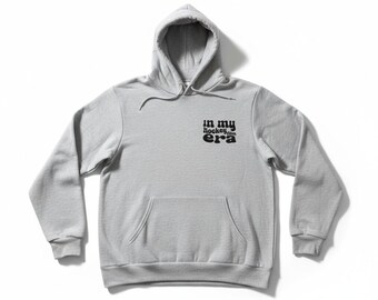 In My Hockey Mom Era Pullover Hoodie, Cotton/Poly Blend, Unisex Ash (8 oz)
