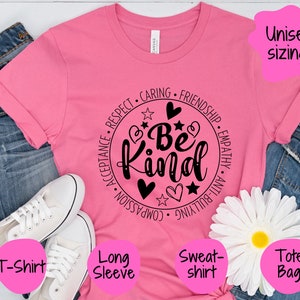 May include: Pink t-shirt with a black circle design that says "Be Kind" surrounded by words like "Respect", "Caring", "Friendship", "Acceptance", "Compassion", "Anti-Bullying", and "Empathy".