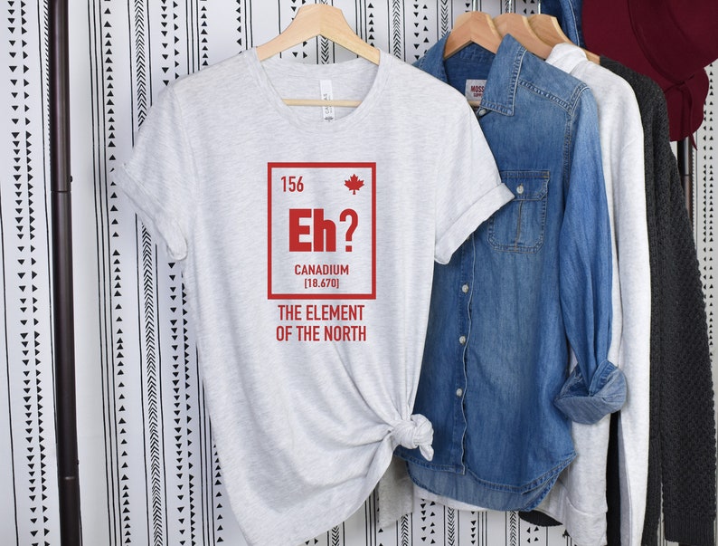 May include: A gray t-shirt with a red graphic of a Canadian flag and the text "Eh? Canadium [18.670] The Element of the North".