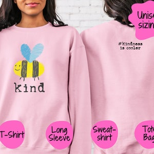 May include: Pink long-sleeved sweatshirt with a cartoon bee and the word "kind" printed on the front. The back of the sweatshirt has the text "#Kindness is cooler". The sweatshirt is available in unisex sizing.