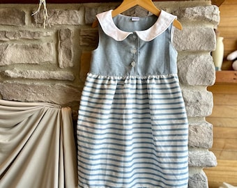 little girl's boat neck dress, lace at the collar, sleeveless, buttoned at the front, several colors