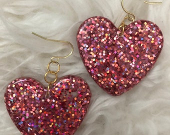 Large pink glittery resin heart shaped Valentine’s Day earrings