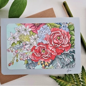 May include: A greeting card with a floral design featuring a bouquet of pink, red, white, and blue flowers on a light blue background. The card is gray with a white border.