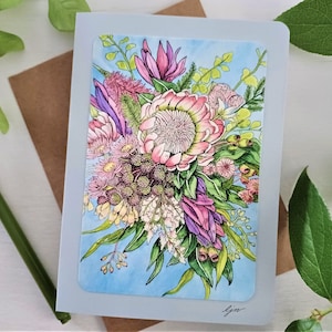 May include: A greeting card featuring a watercolor illustration of a bouquet of pink, purple, and green flowers on a light blue background. The card is signed "Gina".