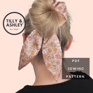May include: A PDF sewing pattern for a floral print hair scrunchie with a bow. The pattern is from Tilly & Ashley, Est. 2020.