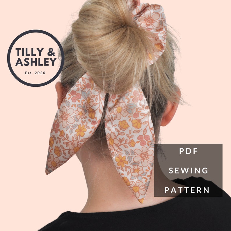 May include: A PDF sewing pattern for a floral print hair scrunchie with a bow. The pattern is from Tilly & Ashley, Est. 2020.