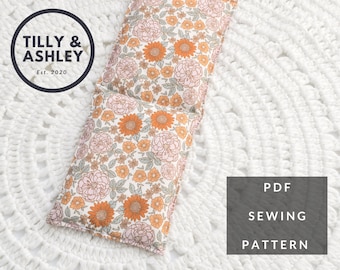 May include: A PDF sewing pattern for a floral print hot water bottle cover. The cover is made of three sections and has a white background with orange and pink flowers.