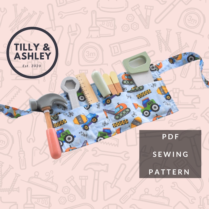 May include: A PDF sewing pattern for a blue and yellow tool belt with a construction vehicle print. The belt has pockets to hold tools like a hammer, wrench, and ruler. The pattern is for a DIY project and includes instructions for sewing the tool belt.