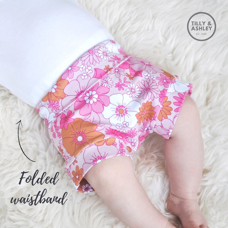 May include: Pink and orange floral print baby bloomers with a folded waistband. Tilly & Ashley Est. 2020.