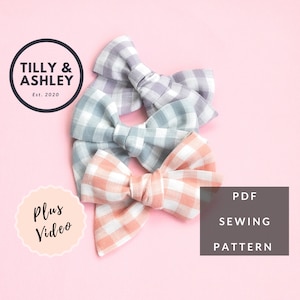 May include: Three gingham fabric hair bows in pink, blue and purple. The bows are stacked on top of each other. The text "Plus Video" is in a circle on the left side of the image. The text "PDF Sewing Pattern" is on the right side of the image.